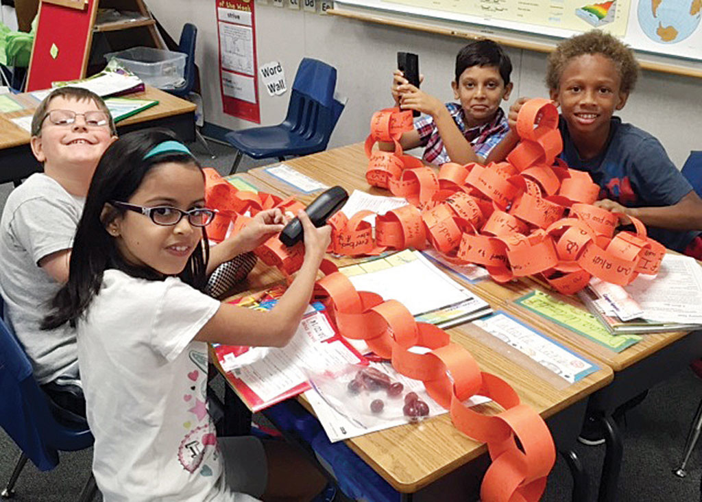 Third-grade students create a Unity Chain. (Top row, l-r): Nabeel Bangosh, Justin Mack. (Bottom row): Ryker Morgan, Natasha Kanga.