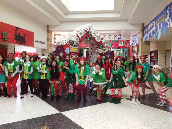 A choir ensemble of elves performed holiday songs in front of Santa’s Workshop.