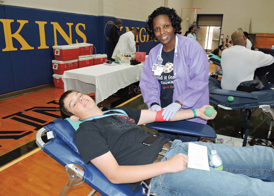 Donor Technician Alesia McLemore preps student David Sander.