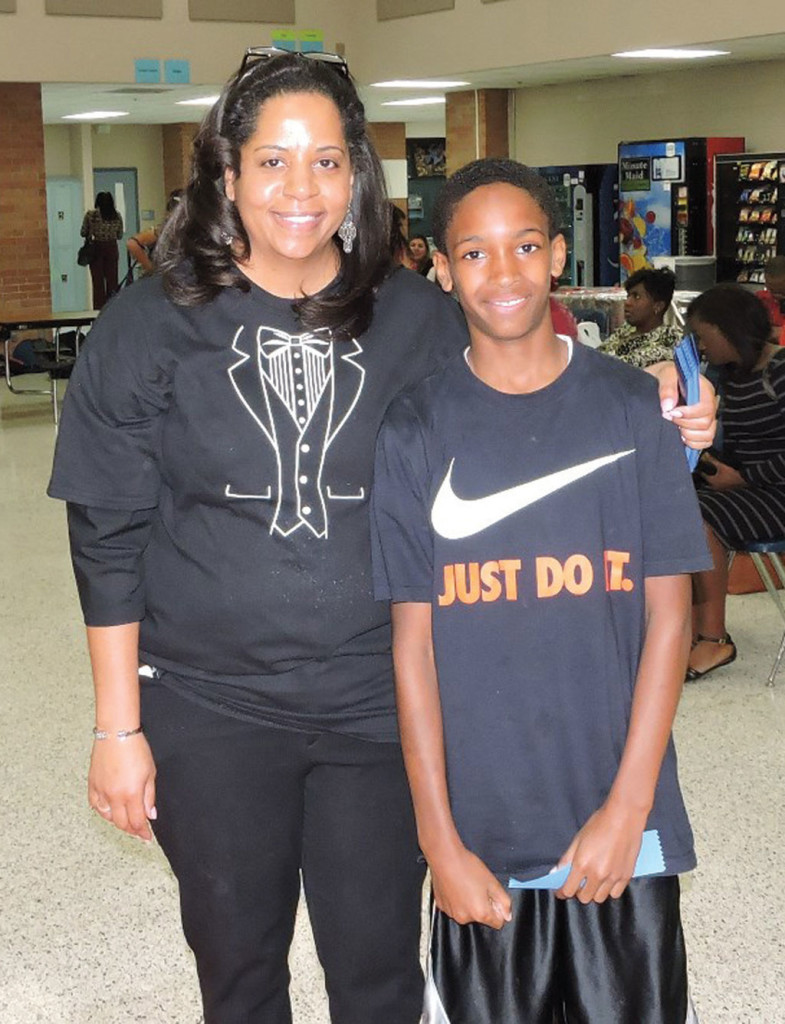 Principal Deirdre Holloway with sixth-grade, A-B Honor Roll student Koy Glover.