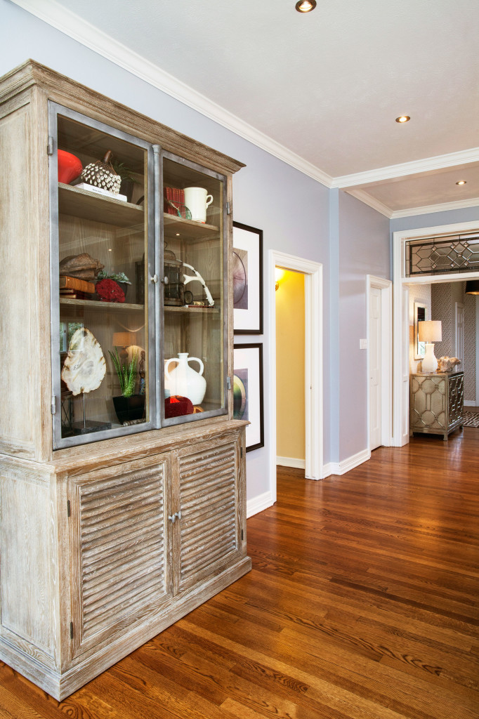 A large cabinet by Brownstone, purchased from James Craig Furnishings, holds a collection of accessories the couple has acquired from world travels. 