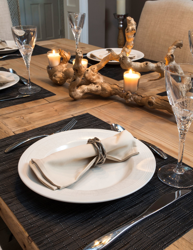 A large cabinet by Brownstone, purchased from James Craig Furnishings, holds a collection of accessories the couple has acquired from world travels.  