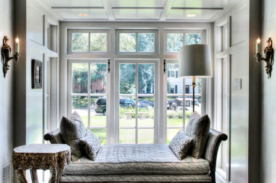 A feature reading nook uses every space in this vestibule leading to the great room. Embellished by a glaze the paneling is a subtle transition from the plaster walls it is next to. Sources: Schmacher Gainsborough velvet in Stone from Lelievre Reso on 18th c. Italian settee. Plaster by Segreto.