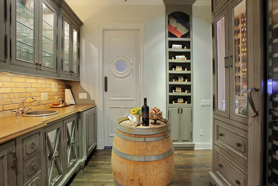 The wine bar, which Stacey designed, includes an antiqued Rocky Mountain brick backsplash with custom wine label tiles from Architectural Design Resource.