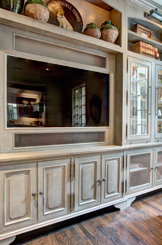 The blue/gray colors from the kitchen were pulled into the den cabinets, which were physically distressed and layered with stains.