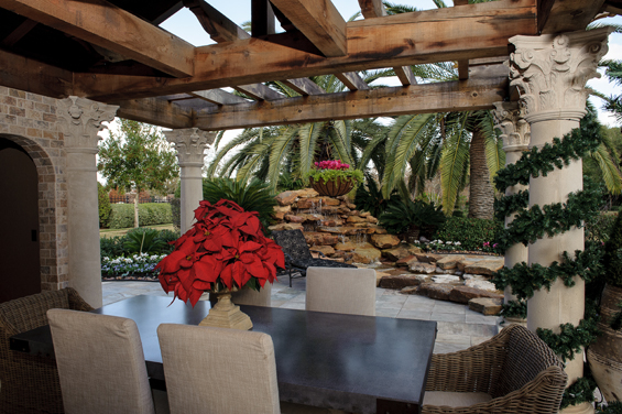 This outdoor living space, overlooking the pool and golf course, is a perfect spot to enjoy cookies and hot cider by the fireplace.