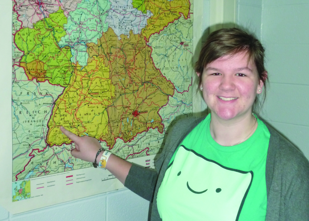 Madison Reese points to her travel destination.