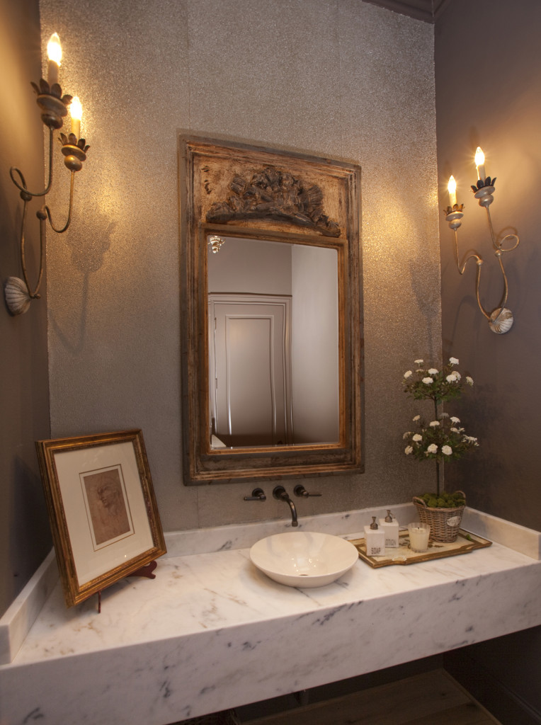 Powder bath has honed Calacatta Marble, mirror from Round Top, wallpaper from Donghia (Decorative Center Houston).