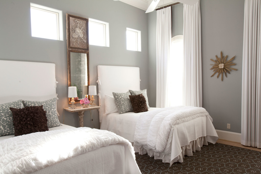 This guest room is outfitted for the grandchildren. Custom twin beds and slip covers by the Joseph Company; nightstand and mirror from Joyce Horn Antiques; bedding from Plush Home.