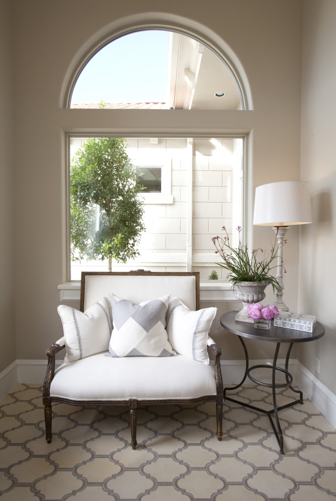 A settee from Round Top is beautifully framed by the window. Tile floor from Walker Zanger.