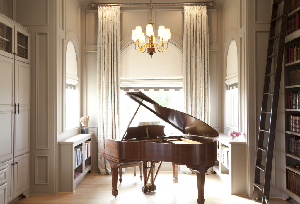 In the doctor’s study, the piano takes center stage. Custom draperies are a Zimmer Rhode fabric, with linen Roman shades. Lighting from Circa.