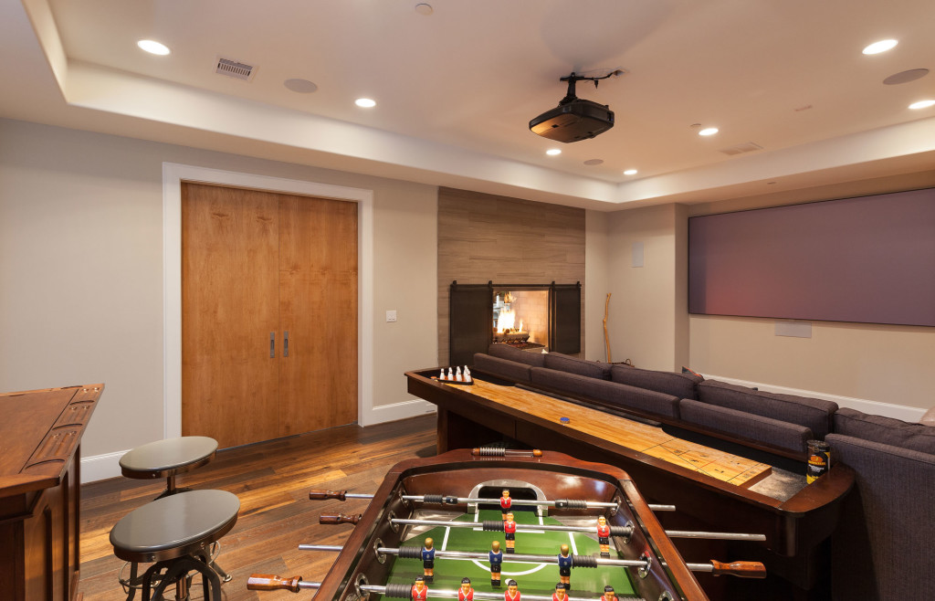 This game room has something for everyone, from the big screen projection TV to shuffleboard to foosball. The bar doubles as a casino game table. The large French doors and the double-sided fireplace both open to the common living areas making this room a natural extension for parties and entertaining.