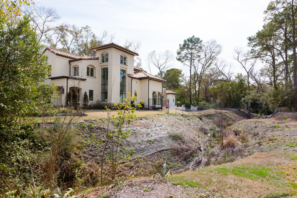Many extraordinary features of this custom home are evident from the backyard view. From the landscaping to the expanse of the home to the rooflines, each element speaks of luxury and ele
