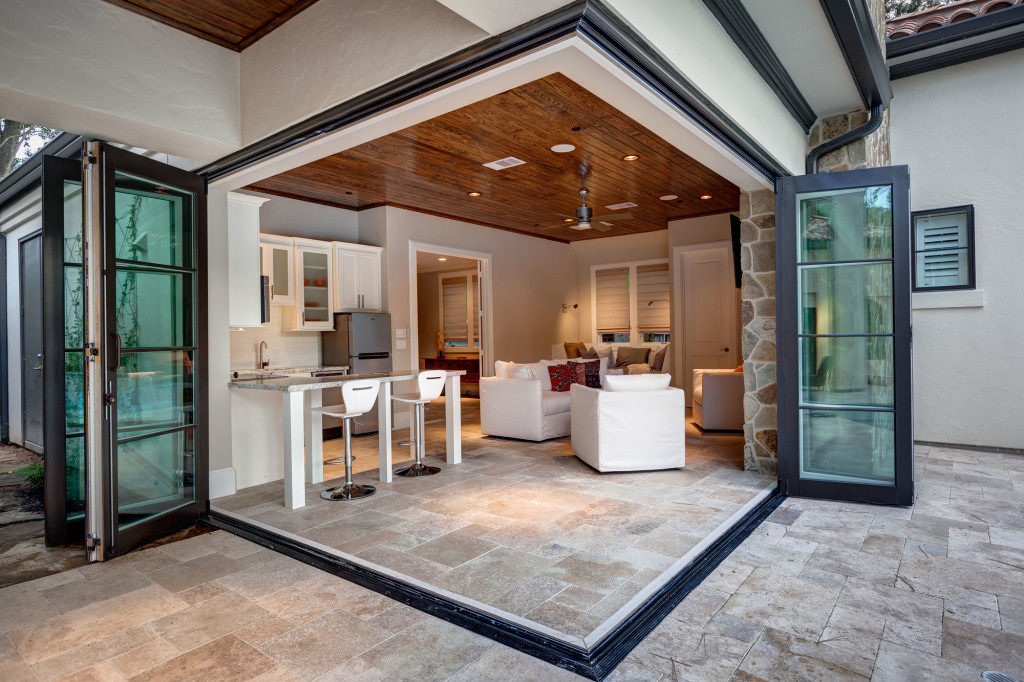 The casita doubles as a guest cottage or more space for entertaining outdoors. With a simple fold back of the glass walls, the space opens up and allows for cooking, serving or lounging by the fireplace.