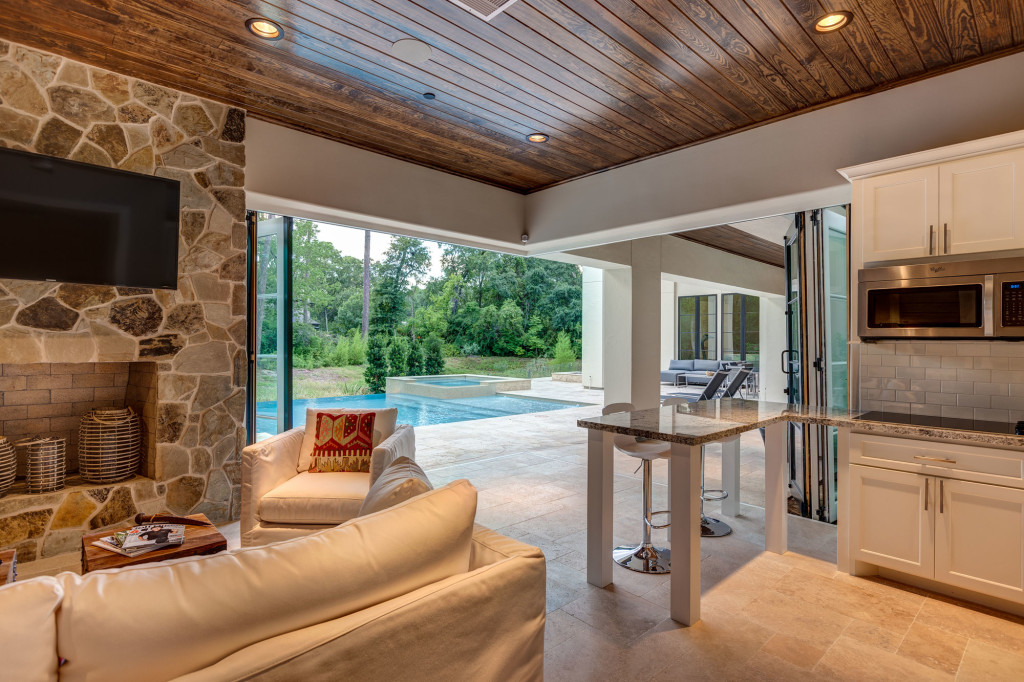Inside the casita, the view is an infinity edge pool overlooking green space on the banks of a creek. Guest and homeowners alike enjoy the solitude and peacefulness this space affords.