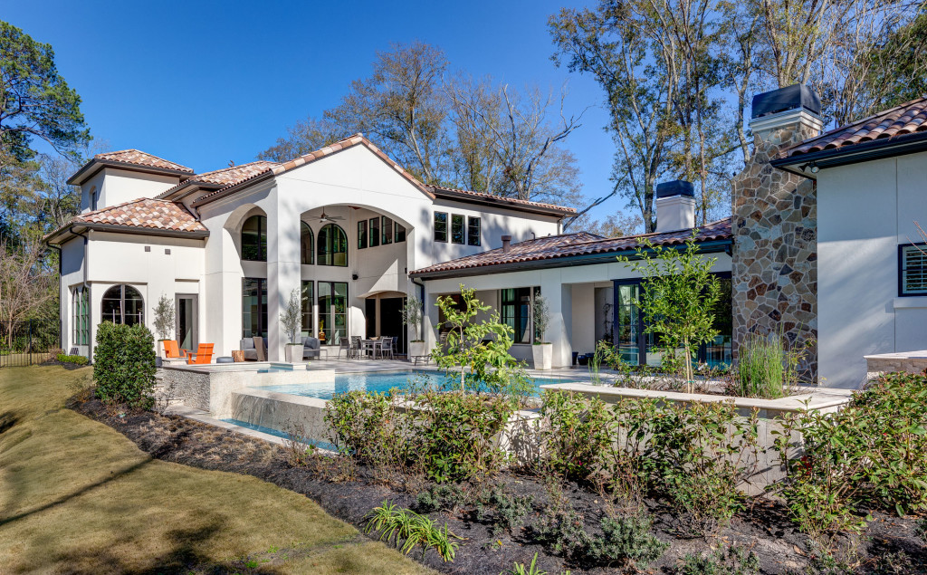 Many extraordinary features of this custom home are evident from the backyard view. From the landscaping to the expanse of the home to the rooflines, each element speaks of luxury and elegant detail.