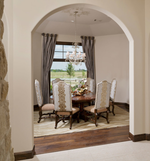 The dining room boasts sweeping views of the lake, and a spectacular chandelier centers over the dining room table highlighting the faux painted medallion on the ceiling. Hardwood floors by Floors Inc. grace this space as well as a large picture window overlooking the backyard.