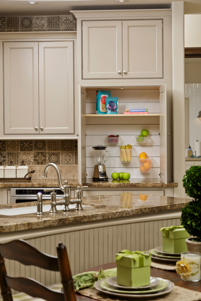 A smoothie station (or baking center) sits conveniently just behind the island and out of sight when cabinet doors are closed.
