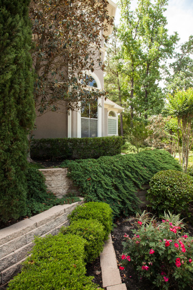 Lush landscaping within terraced walls add to the home’s curb appeal. 
