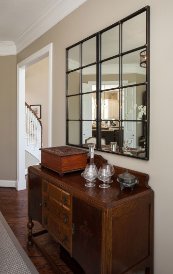 This paneled wall is a showstopper in the home’s updated living room. The custom wall treatment was created by MKD. A soft furniture palette with hints of citrine and metallics makes for a sophisticated space.