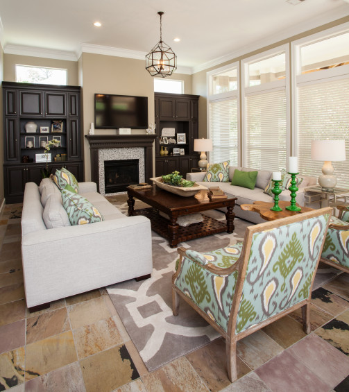 The couple really enjoys the oversized sofas. “We have lots of seating in this room for entertaining,” the homeowner says. While she enjoys the overall neutral tones, soft punches of color add interest and just the right amount of diversion in the space.