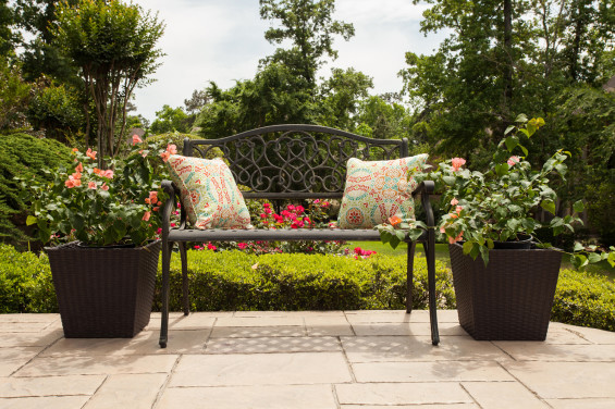 Even the walkway up to the home is eye-catching with a bench with comfy pillows providing visual interest on a front terrace.