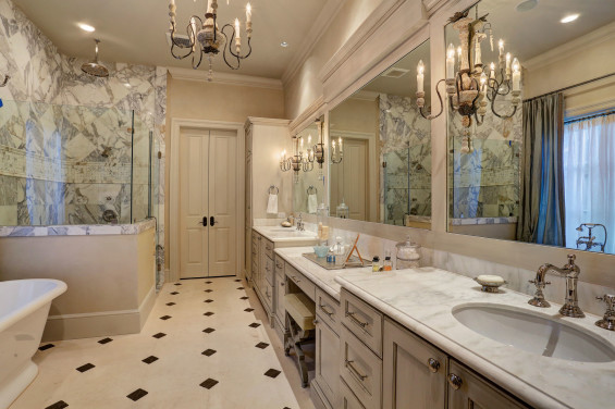 Carrera countertops are a must-have for a light and airy master bath. The light fixtures are Circa, floors by Materials Marketing and plumbing fixtures are Hollywood Hardware.