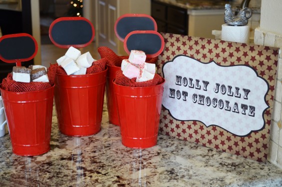 Bright red tin cups were filled with red burlap and topped with fluffy marshmallows to create the appearance of cups of hot chocolate.