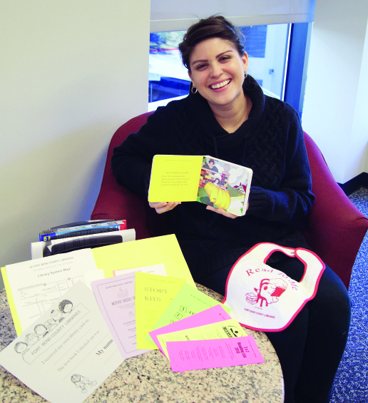 Jamie McKenna shows some of the items in the Baby Book Bags.