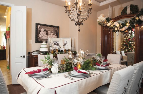 A custom-made tablecloth, monogrammed linen napkins, fresh magnolia garland with antique teapots create the perfect setting for Christmas dinner.