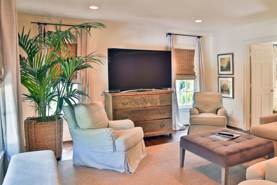 The sitting area off the upstairs master bedroom is the perfect place for winding down at the end of the day. Chest from Antiques & Interiors; ottoman from Area.