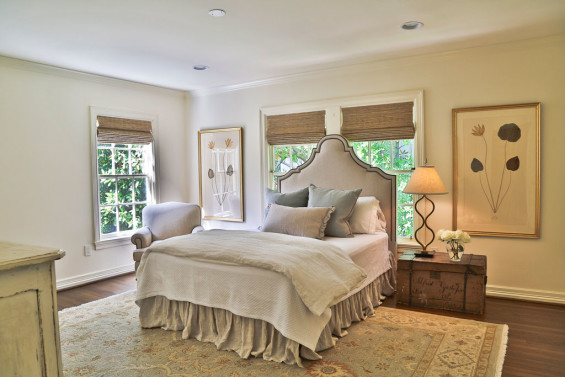 Beautiful herbiers from Boxwood flank the bed in the guest bedroom. The custom headboard is also from Boxwood and bedding from Kuhl Linscomb. The vintage traveling trunk was the homeowner’s bargain find.