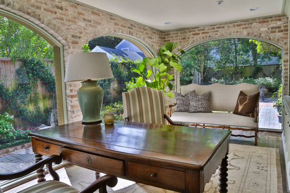 The homeowner’s favorite room in the house, the library, is a stunner with brick walls and expansive arched windows. Chairs are from Hien Lam and the French settee was purchased from MAI.