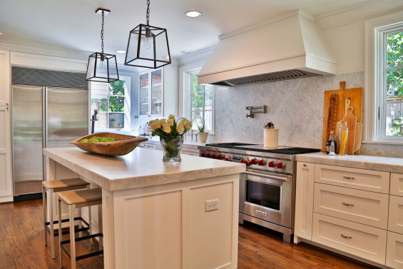 The kitchen was gutted and given new life with carrara marble countertops and backsplash, larger windows and lighting from Brown. The remodel was a collaborative effort between mother-daughter design duo, Dot & Dana, and kitchen designer, Patti Perrier.