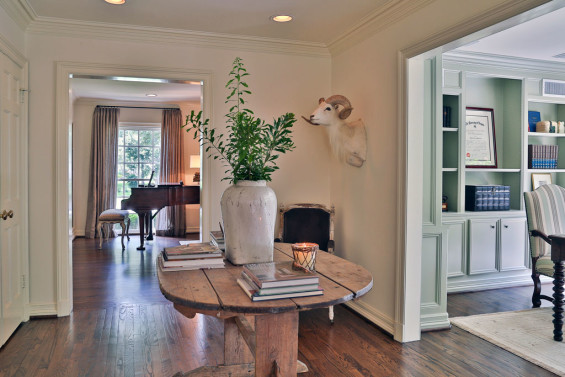 A spacious hallway off the formal living room and study is elegantly outfitted with a Belgian table from MAI. The ram’s head was handed down from family.