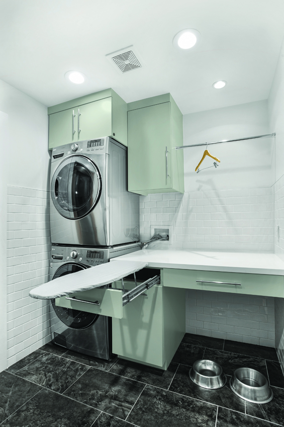 In the utility room, stacked washer and dryer conserves space and a hideaway ironing board makes quick work of wrinkles.
