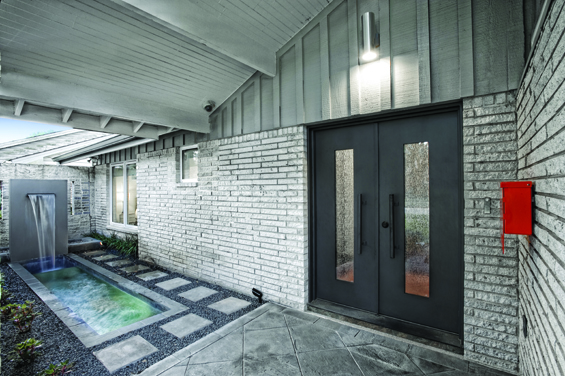Custom designed doors from Cantera, as well as the shape of the fountain pool, replicate the vertical brick slits in the courtyard walls.