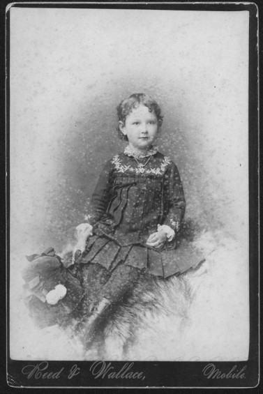 Cabinet card of a young girl in a dress.