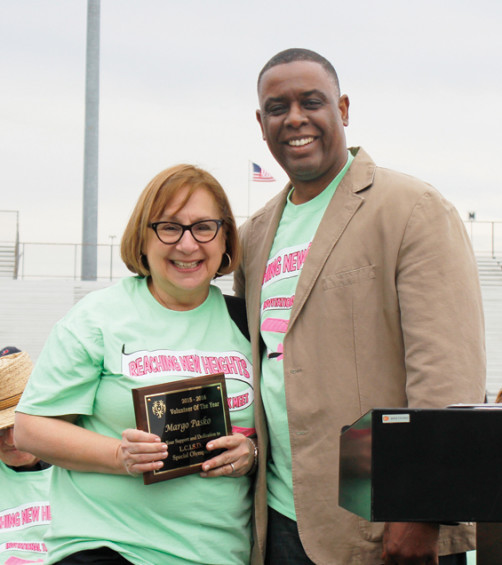 Margo Pasko receives the Volunteer of the Year award from Dr. Michael Milstead, principal at LCHS.