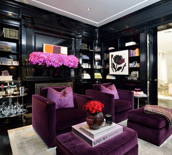 The library is in direct contrast with the rest of the home's monochromatic white palette. This room is equally stunning with black lacquer floors and walls. The Art Deco furnishings and accents are punctuated with a stunning orchid arrangement on the mantle. Art by Dana Frankfort and Donald Baechler.